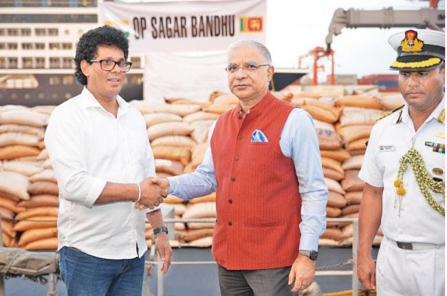 Indian High Commissioner Santosh Jha hands over part of India’s extensive relief assistance for Cyclone Ditwa to Minister Wasantha Samarasinghe.