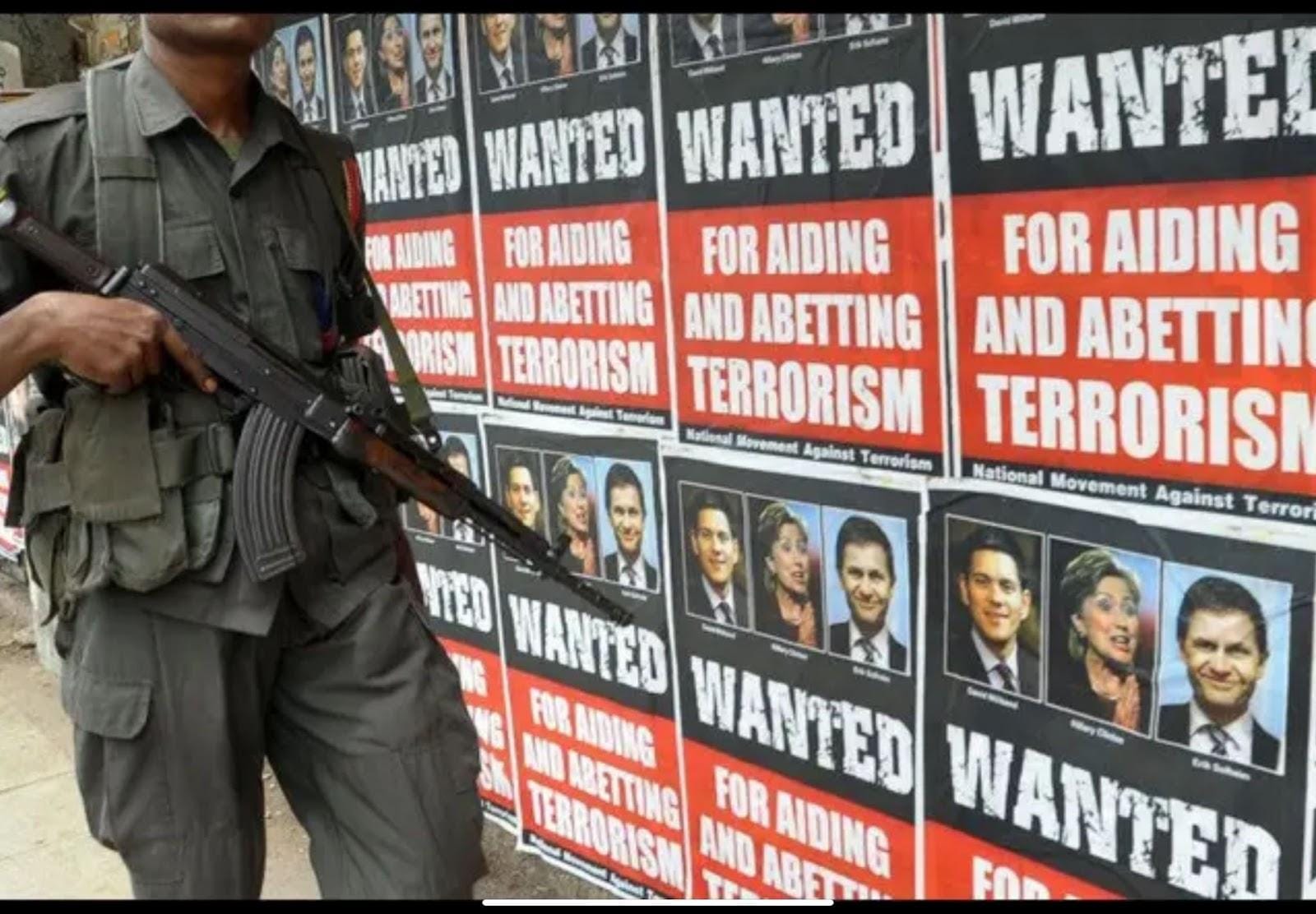 On April 29, 2009, in Colombo, a Sri Lankan army trooper passes by posters accusing British Foreign Minister David Miliband, US Secretary of State Hillary Clinton, and Norwegian International Development Minister Erik Solheim of supporting terrorism in SriLanka.