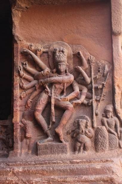The dancing Shiva wall carvings from the Badami (Vatapi) and Elora caves from the Deccans. The early Chalukya rulers (6th – 8th century AD) who ruled from Vatapi (modern day Badami) and the subsequent Rashtrakuta rulers (8th-10th century AD) are credited with these rock carvings. They show Shiva both as a ferocious destroyer with multiple arms and weapons and a more graceful figure exuding calm and as a graceful protector. With both legs firmly planted on the ground (Acknowledgements: Google Images).