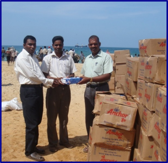 Dr. Sathiyamoorthy, Dr. Varatharaja, and then-Acting Government Agent Parthiepan receive a consignment of milk powder sent by IMHO in the No Fire Zone on April 1, 2009, during the final phase of the brutal Sri Lankan war.